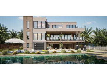 Modern two-story home with a backyard pool, lounge area, and ample outdoor seating at 7176 S Shore Dr, South Pasadena, FL 33707