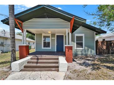 Charming single-story home with a covered front porch and brick-accented columns at 1312 E Louise Ave, Tampa, FL 33603
