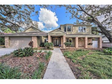 Two story house with landscaping and walkway at 13811 Shady Shores Dr, Tampa, FL 33613