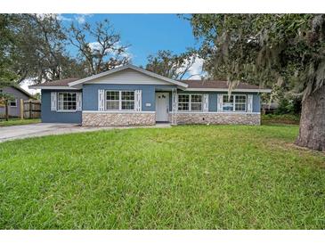 Newly renovated blue house with stone accents and a spacious yard at 1611 Cedar Dr, Plant City, FL 33563