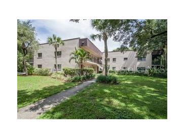 Two story building with lush green landscaping at 11701 Raintree Village Blvd # C, Temple Terrace, FL 33617