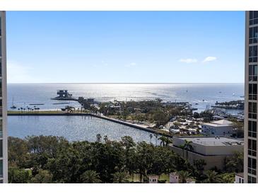 Expansive waterfront view of bay with pier and boats from high-rise condo with bright sunny skies at 126 4Th Ne Ave # 1302, St Petersburg, FL 33701