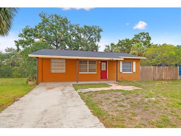 Charming single-story brick home with a red front door and well-maintained lawn in a quiet neighborhood at 225 35Th N St, St Petersburg, FL 33713