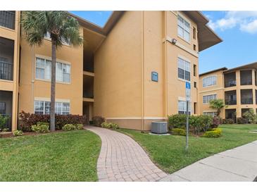 Condo building exterior with walkway and landscaping at 4305 Bayside Village Dr # 104, Tampa, FL 33615
