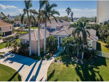 Beautiful home exterior with palm trees and landscaping at 5944 Bay S Dr, Gulfport, FL 33707