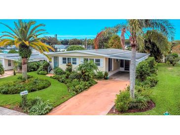 Yellow single-story home with lush landscaping and palm trees at 270 Independence Ave # 10, Palm Harbor, FL 34684