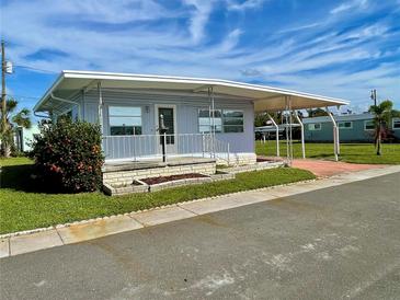 Single-wide manufactured home with carport and landscaping at 34539 Violet N Dr, Pinellas Park, FL 33781
