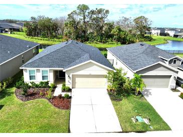 Aerial view of two-story house with landscaped yard at 8519 Sunshower Pl, Parrish, FL 34219