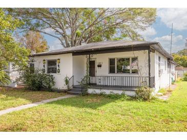 Charming bungalow-style home with a white exterior and a black roof at 1840 21St N Ave, St Petersburg, FL 33713