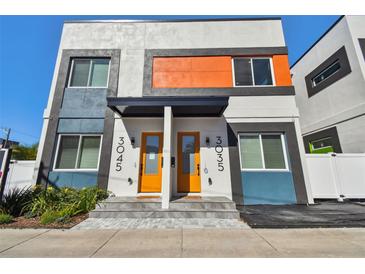 Modern townhomes featuring bright color accents, covered entries, and contemporary design elements at 3035 1St S Ave, St Petersburg, FL 33712