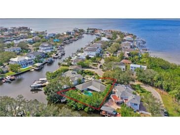 Aerial view of a waterfront home with a private pool and lush landscaping at 5104 W San Jose St, Tampa, FL 33629