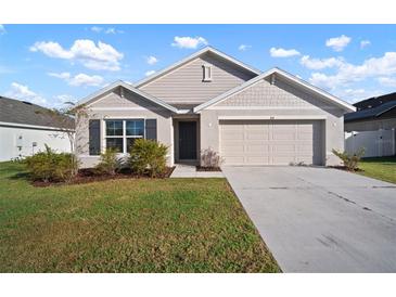 Charming one-story home with two-car garage and manicured lawn at 810 Tidal Rock Ave, Ruskin, FL 33570