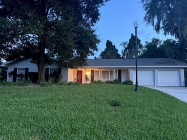 One-story home with white exterior and landscaping at 621 S Sylvan Dr, Brandon, FL 33510