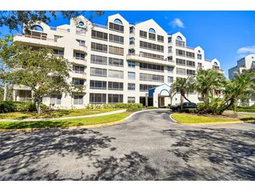 Exterior of a condominium building with parking and landscaping at 2333 Feather Sound Dr # A509, Clearwater, FL 33762