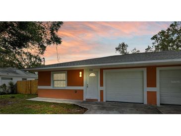 Orange house with attached two car garage at 3330 W Heiter St, Tampa, FL 33607