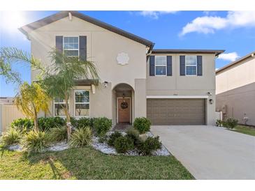 Two-story house with a two-car garage, landscaping, and a neutral color palette at 8968 Parsons Hill Blvd, Wesley Chapel, FL 33545