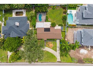 Aerial view of house and surrounding properties with pools at 1015 Snell Isle Ne Blvd, St Petersburg, FL 33704