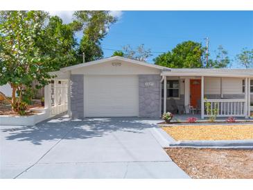 Charming house with a gray stone facade and covered porch at 1537 Excalibur St, Holiday, FL 34690