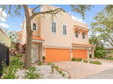 Two-story Mediterranean home with orange garage doors at 604 S Tampania Ave # C, Tampa, FL 33609