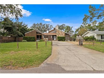 House exterior showcasing a split-level home with stone and wood siding at 715 S Himes Ave, Tampa, FL 33609