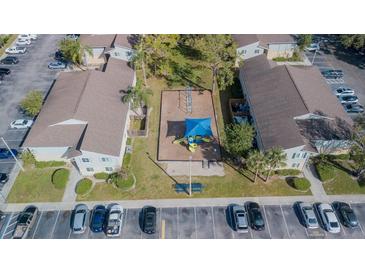 Aerial view of community playground with adjacent parking and residential buildings at 237 Thorn Tree Pl # 237, Brandon, FL 33510