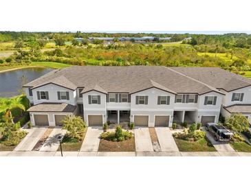 Three-unit townhouse building with attached garages and landscaping at 3632 Bellmeade Ct, Wesley Chapel, FL 33543