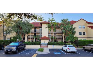 Building exterior with parking and a fountain at 2400 Feather Sound Dr # 527, Clearwater, FL 33762