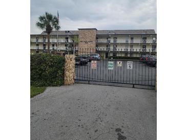 Condo building with ample parking and gated entrance at 6100 12Th S St # 212, St Petersburg, FL 33705