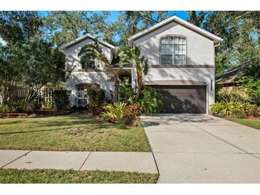 Two-story house with a landscaped yard and a two-car garage at 2457 Hickman Cir, Clearwater, FL 33761