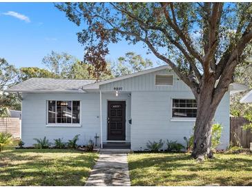Charming light blue house with a dark brown door and landscaped yard at 4237 Dr Martin Luther King Jr N St, St Petersburg, FL 33703