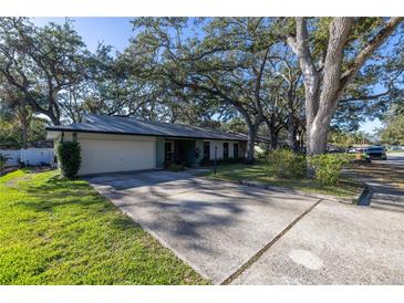 Ranch style home with carport and mature landscaping at 2227 Willowbrook Dr, Clearwater, FL 33764