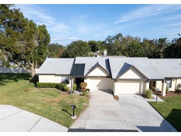 Charming single-story home featuring a well-manicured lawn and inviting curb appeal at 3499 Cedar Ln, Palm Harbor, FL 34684