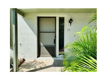 Simple house entrance with brown door and small porch at 1960 Union St # 25, Clearwater, FL 33763