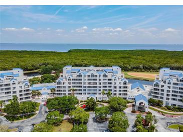 Aerial view of a waterfront condo building with lush landscaping at 2333 Feather Sound Dr # B101, Clearwater, FL 33762