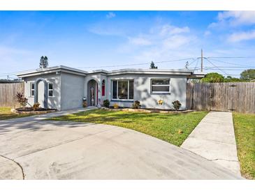 Charming single story home with a red door and landscaped yard at 8815 92Nd Ter, Seminole, FL 33777