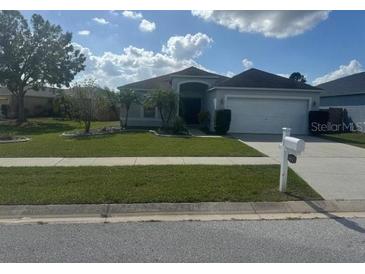 One-story house with attached garage, neat lawn, and a mailbox at 4611 Horseshoe Pick Ln, Valrico, FL 33594