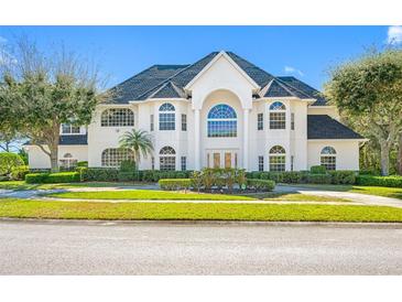 Impressive two-story house with a grand entrance and manicured lawn at 3073 Woodsong Ln, Clearwater, FL 33761
