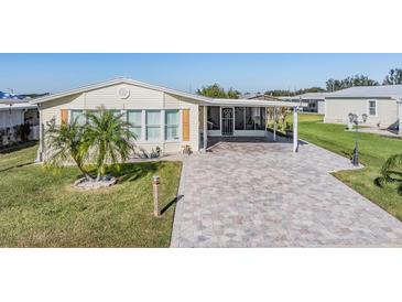 Single-story home with a paved driveway and palm tree landscaping at 37635 Gill Ave, Zephyrhills, FL 33541