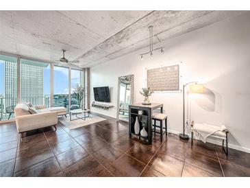 Modern living room boasts city views, dark tile floors, and comfy seating at 777 N Ashley Dr # 1808, Tampa, FL 33602