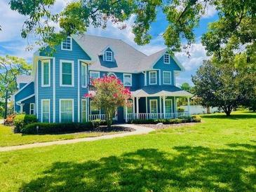 Two-story blue house with a large front yard at 1135 Candler Rd, Clearwater, FL 33765