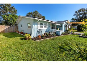 Charming light blue home with well-maintained lawn and landscaping at 306 Inlet Ct, Largo, FL 33756