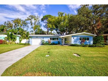 Newly renovated light blue home with a spacious yard at 1042 Idlewild N Dr, Dunedin, FL 34698
