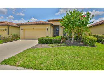 Charming single-story home featuring a well-manicured lawn and a classic tile roof at 5721 Sunset Falls Dr, Apollo Beach, FL 33572