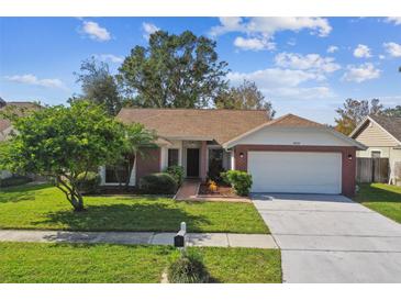 Brick ranch-style home with a two-car garage at 8910 Beeler Dr, Tampa, FL 33626