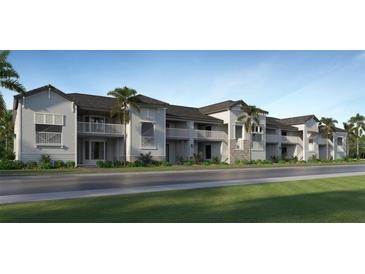 Modern apartment building with balconies and palm trees at 19015 Scallop Loop # 102, Lakewood Ranch, FL 34202