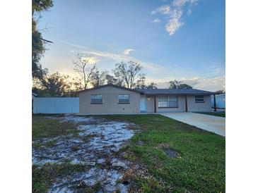 Newly renovated 1-story house with a concrete driveway at 7006 N Orleans Ave, Tampa, FL 33604