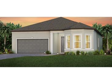 One-story home with gray siding, gray garage door, and landscaping at 11208 Shoreline Trl, Parrish, FL 34219