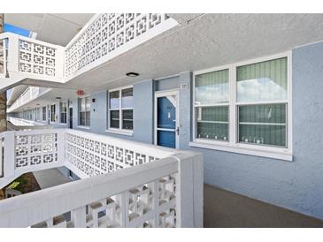 Exterior view of a condo building with a walkway and blue building at 4715 Bay Ne St # 223, St Petersburg, FL 33703