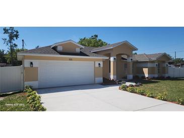Charming single-story home features a two-car garage, manicured landscaping, and a freshly painted exterior at 103 2Nd Ne Ave, Lutz, FL 33549
