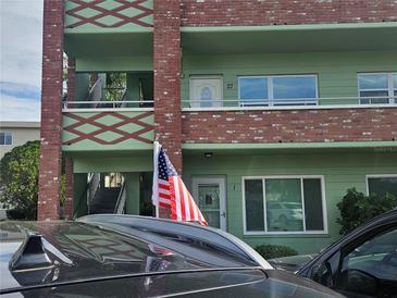Exterior view of a two story building with green and brown accents at 2359 Finlandia Ln # 27, Clearwater, FL 33763